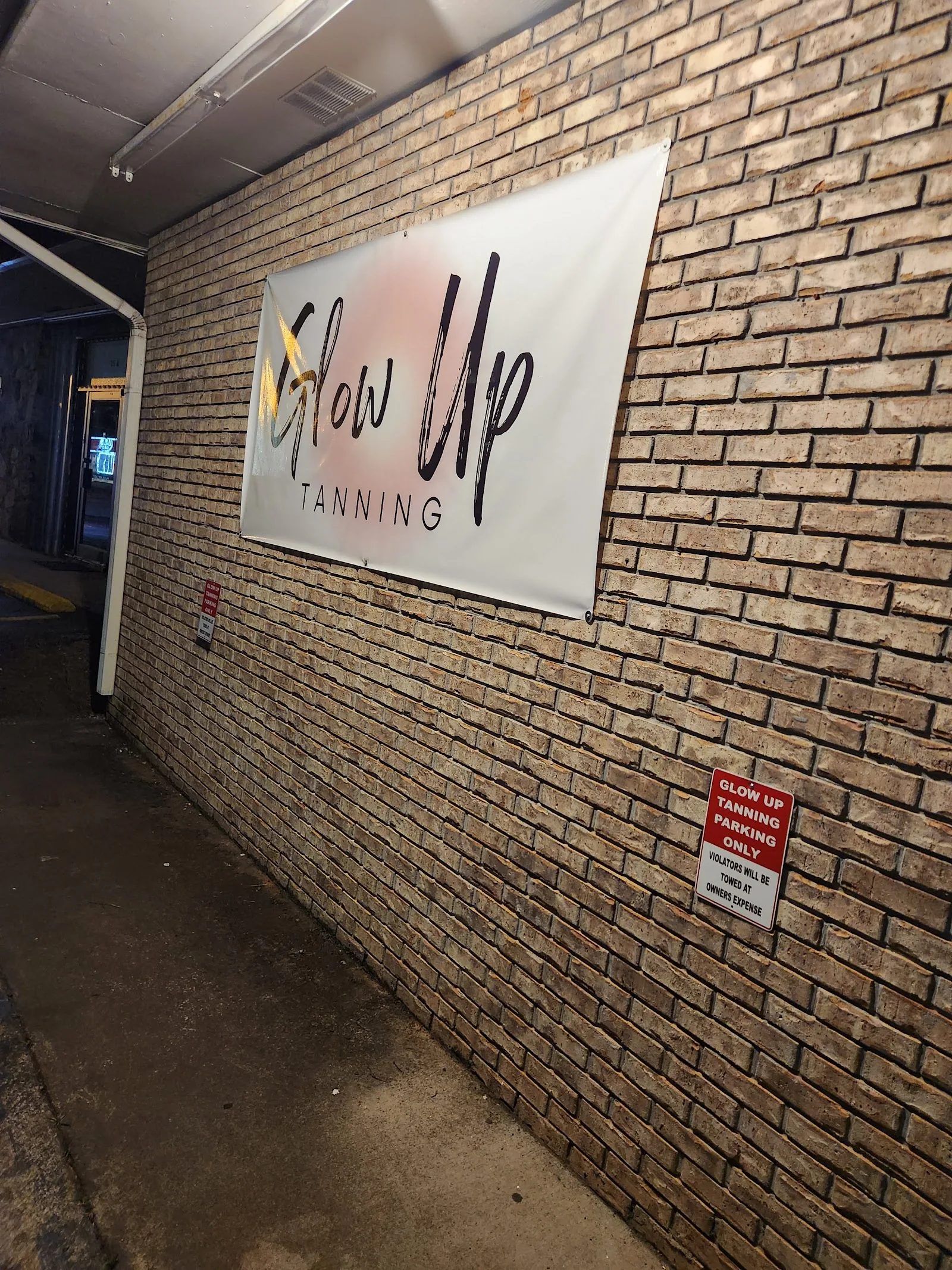 Glow Up Tanning storefront banner in Talladega, AL