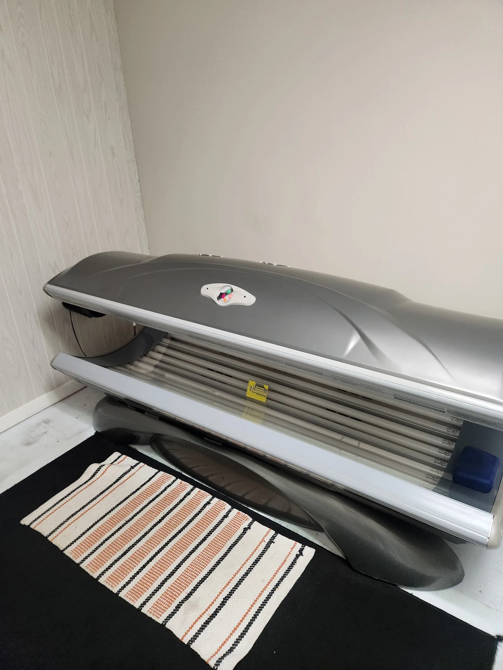 Silver lay-down tanning bed at Glow Up Tanning